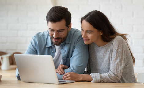 Two people looking at a laptop